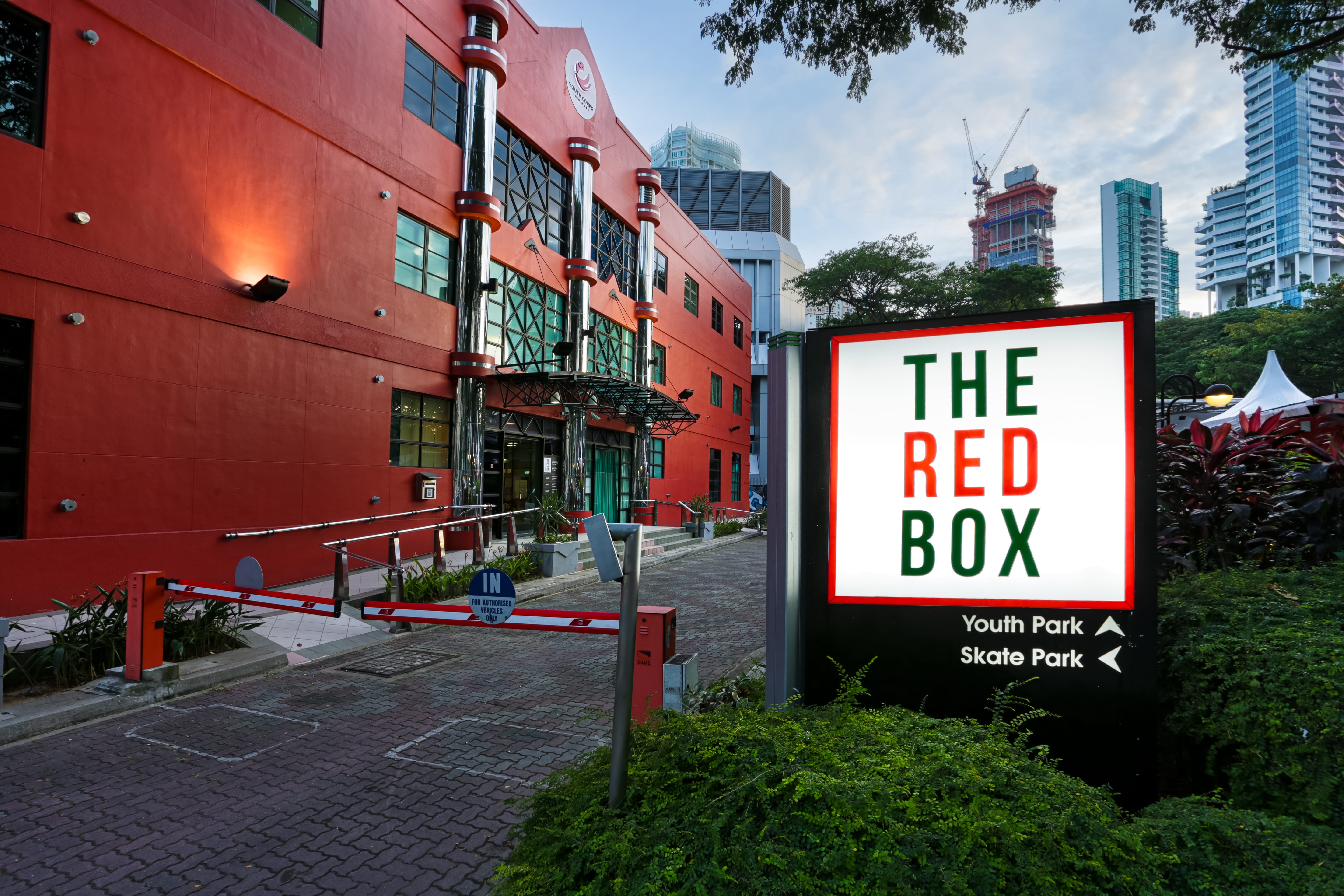 Entrance of The Red Box with sign pointing to Youth Park and Skate Park at Somerset